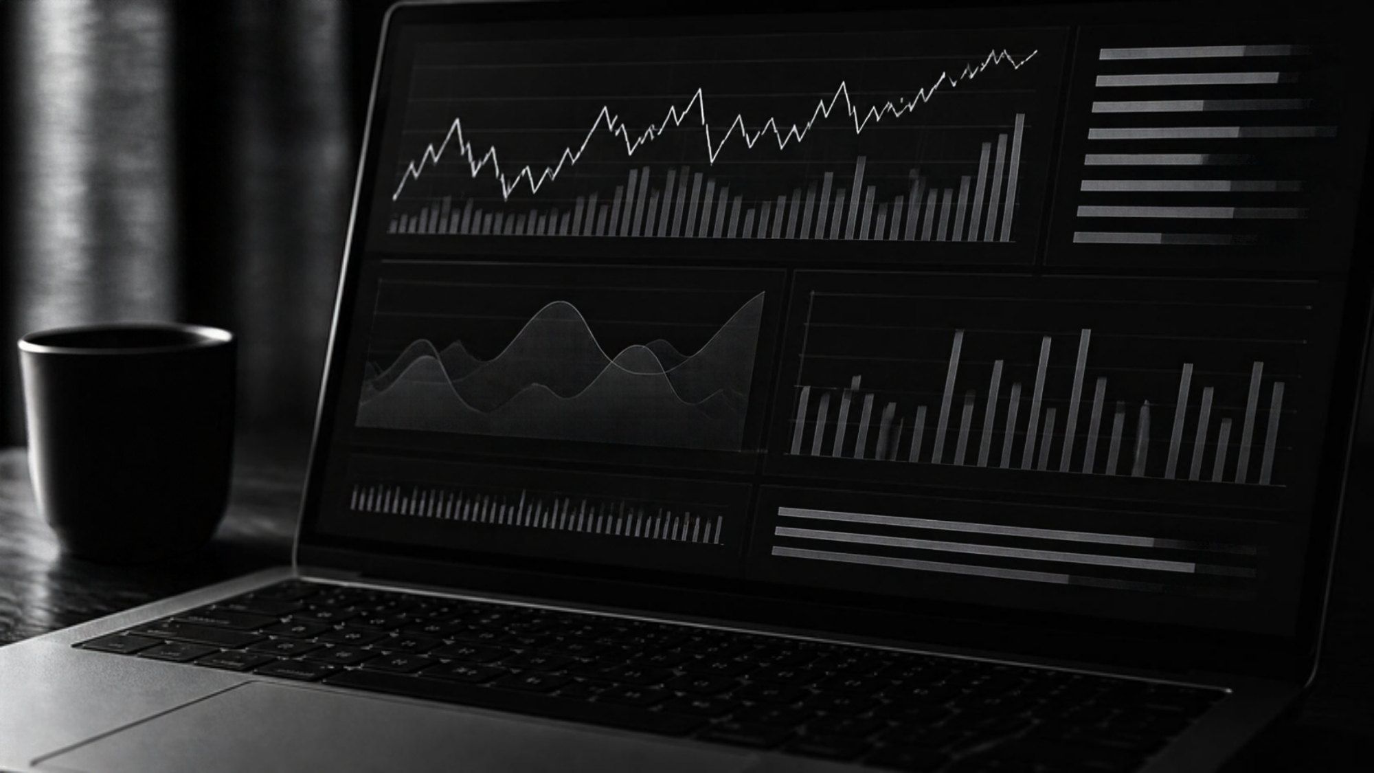 Black and white photo of a laptop showing an analytics dashboard (illustrative image)