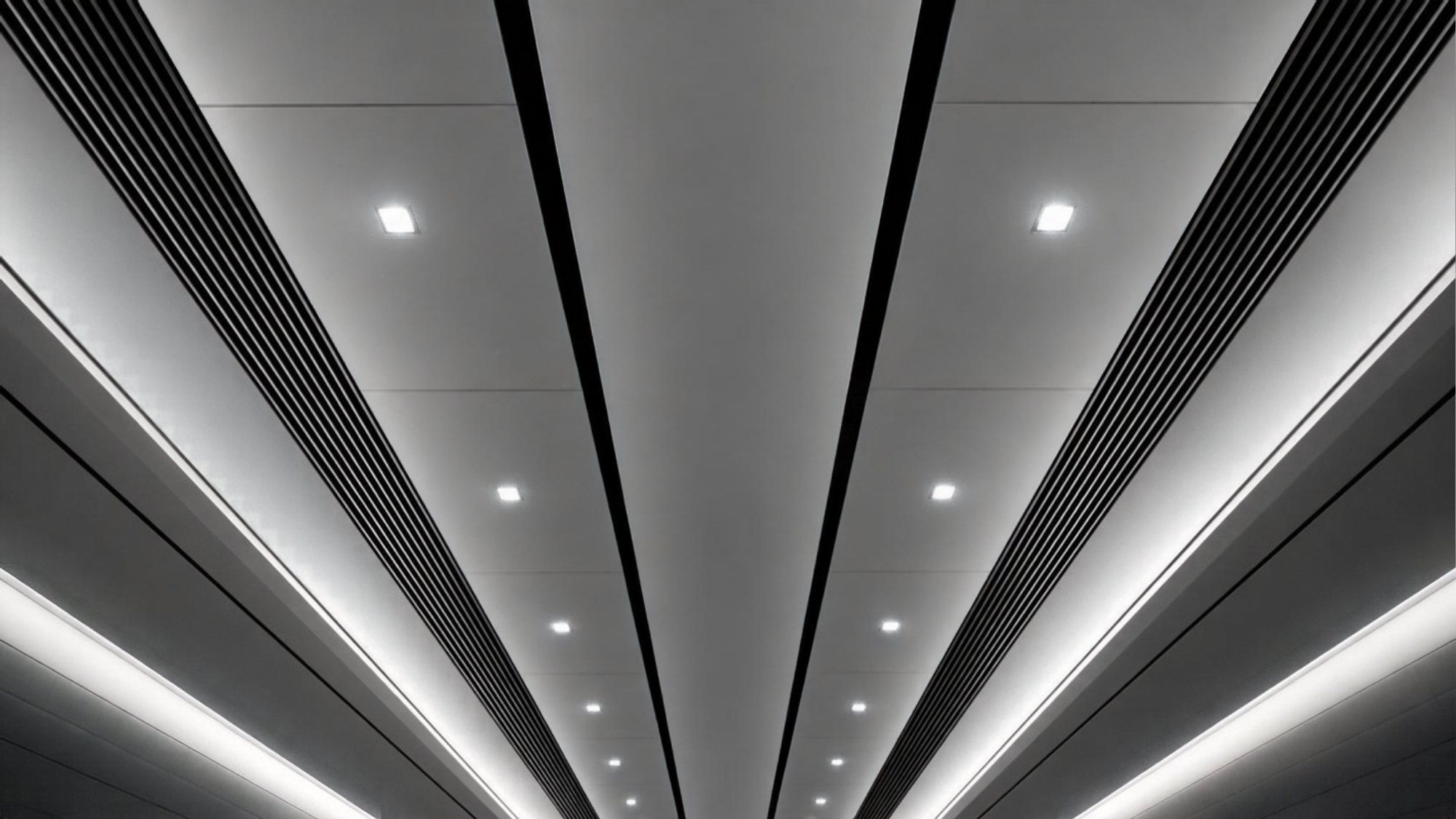 Black and white photo of a modern office ceiling with air vents and lights (illustrative image)