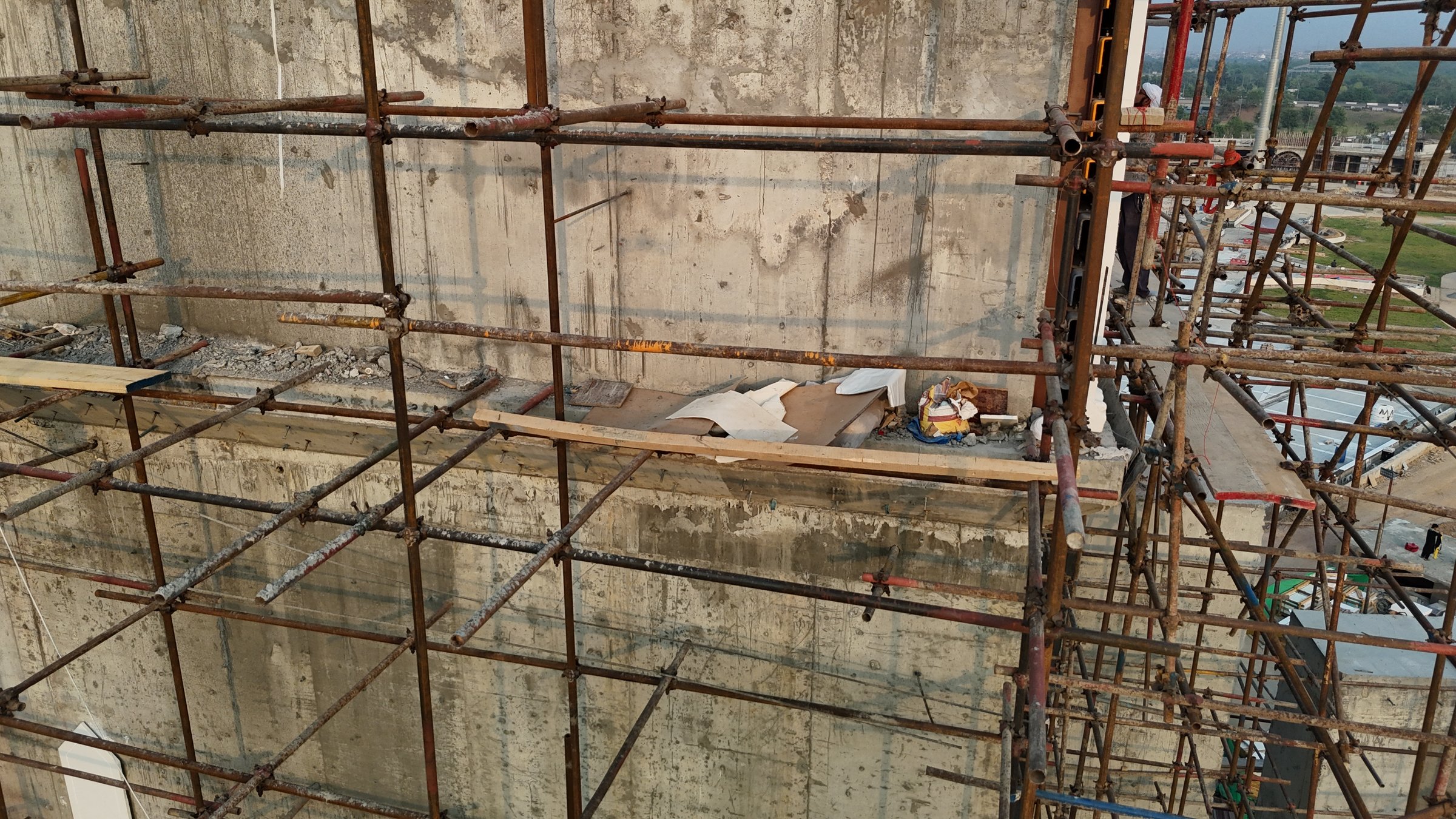 Steel scaffolding erected along the face of a building under construction