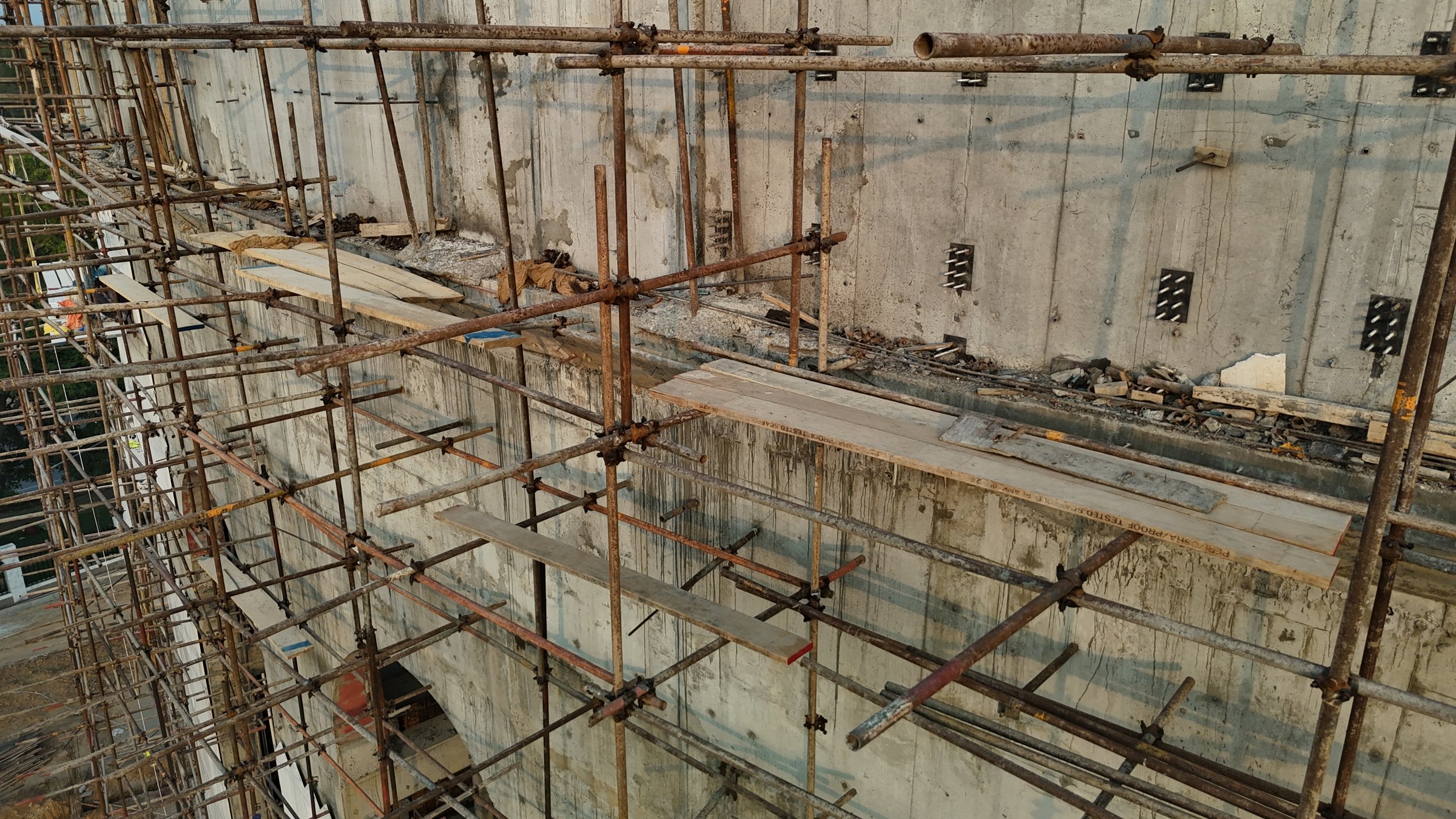 Marble cladding being installed on a scaffolded facade section