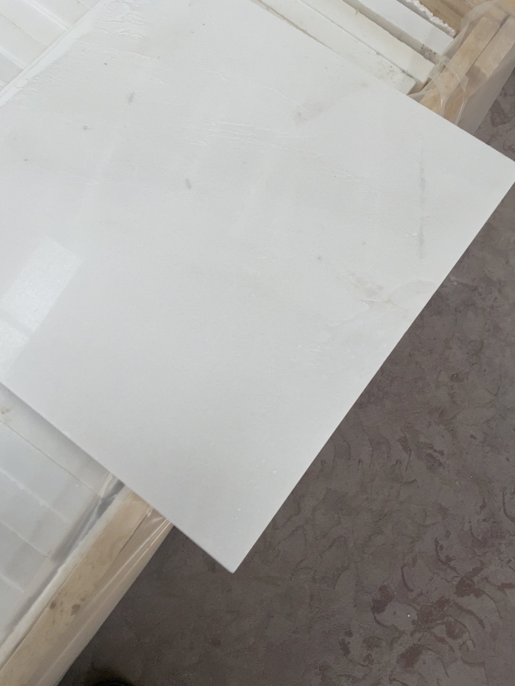 White marble slab resting on a timber shipping crate