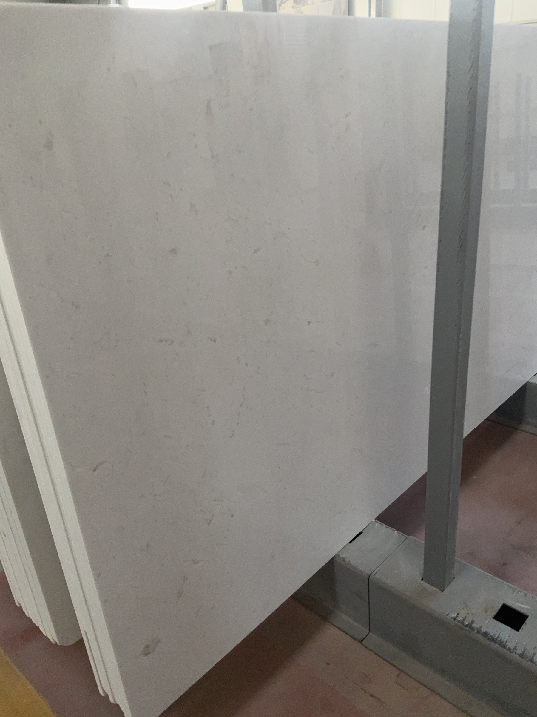 Close view of a light polished marble slab surface showing fine natural veining